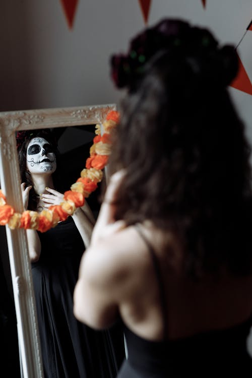 Woman in Halloween Costume Looking at the Mirror