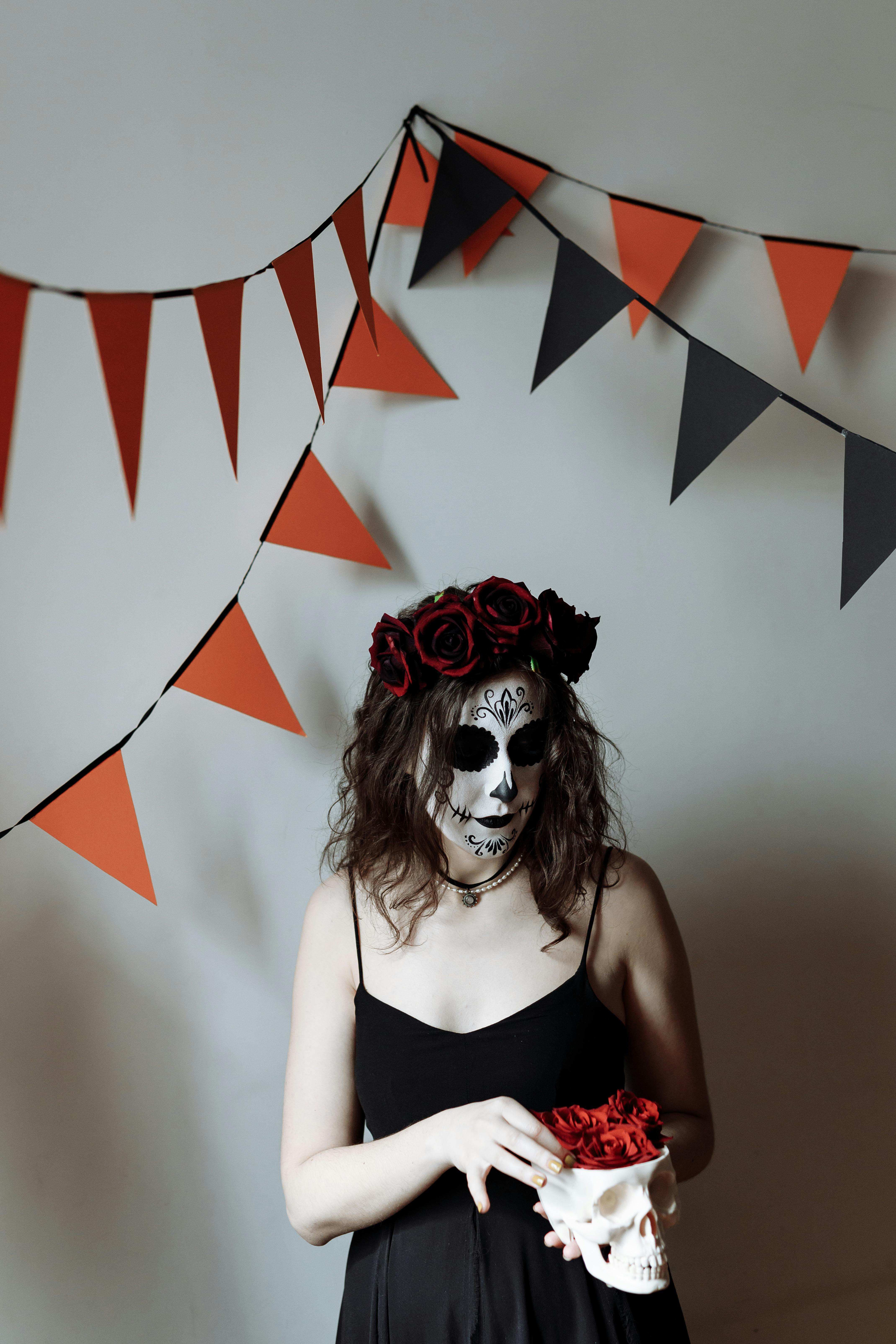 woman in black tank top wearing red and white mask
