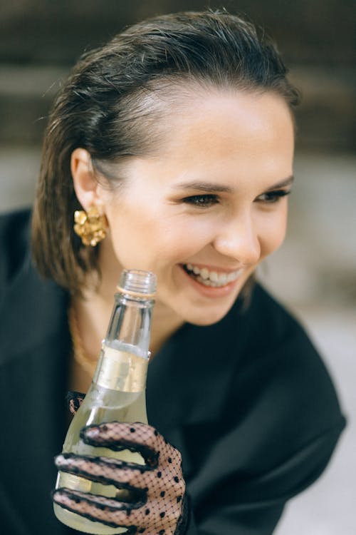 Portrait of a Woman Holding a Bottle of Champagne