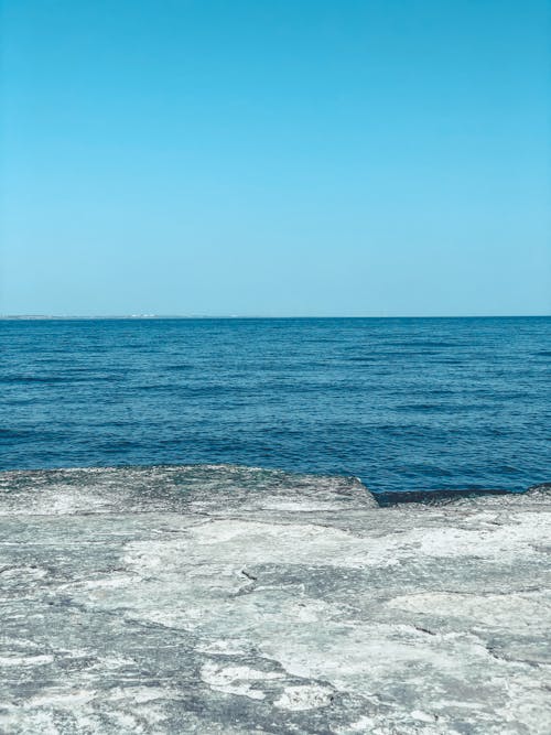 Free Wavy sea under cloudless blue sky Stock Photo