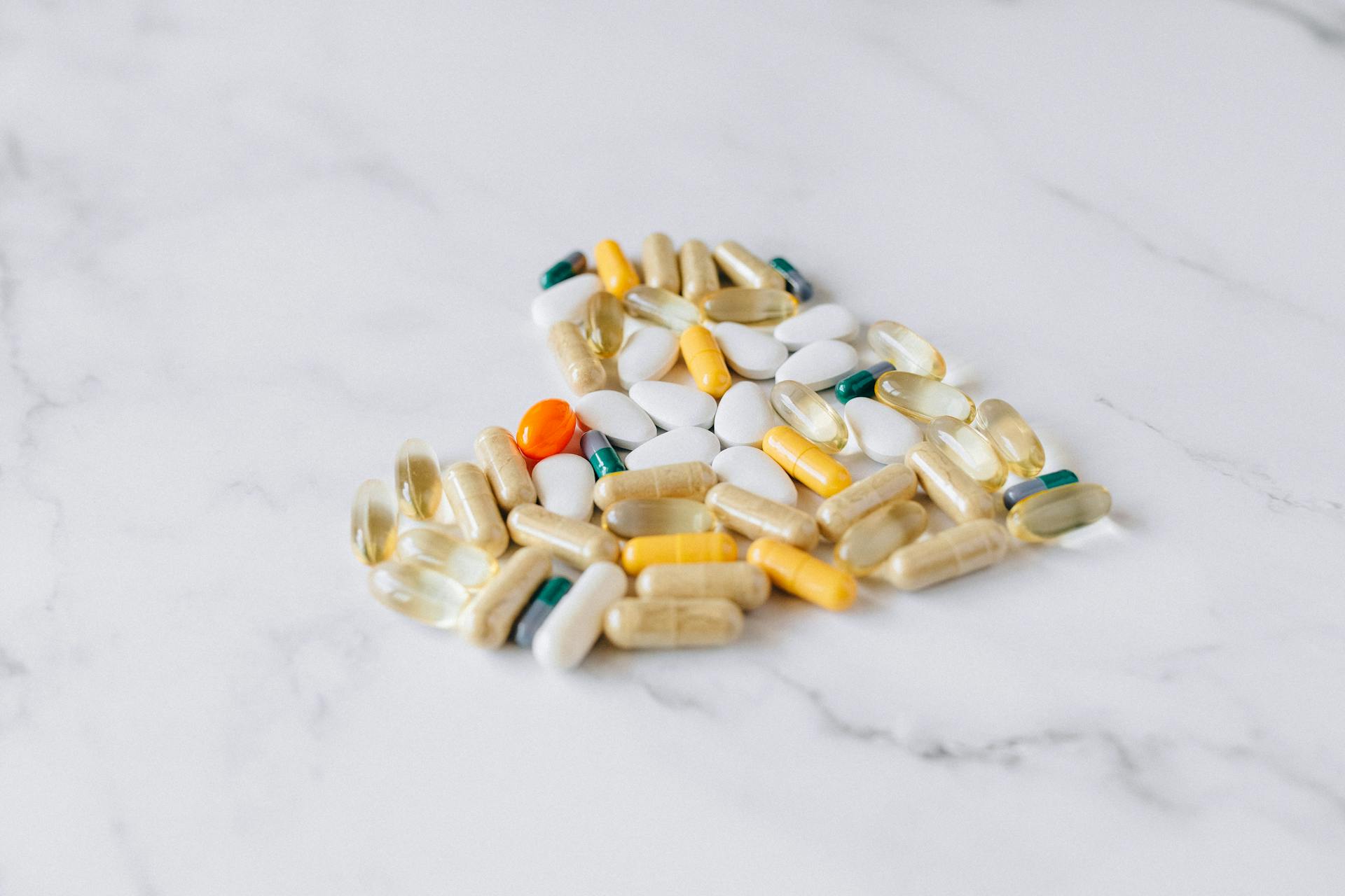 Variety of Supplements and Pills on Marble Surface