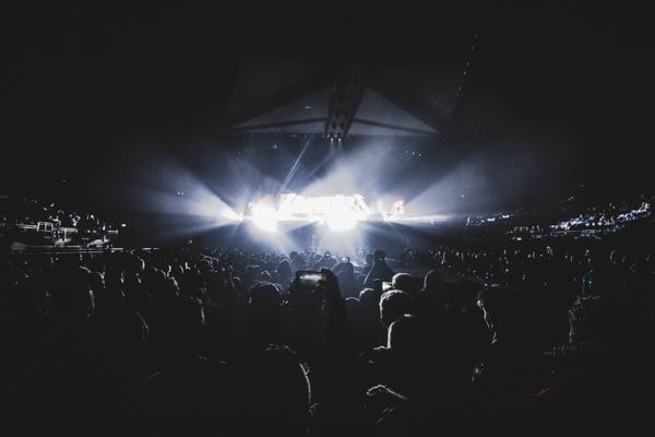 Night stadium crowd under blue light — photo by Jack Gittoes on Pexels