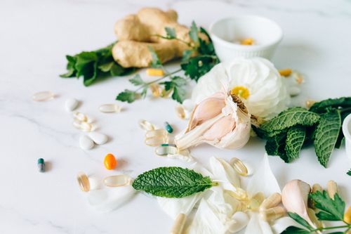 Free A flat lay of various herbal remedies and vitamin supplements, featuring natural herbs and capsules. Stock Photo
