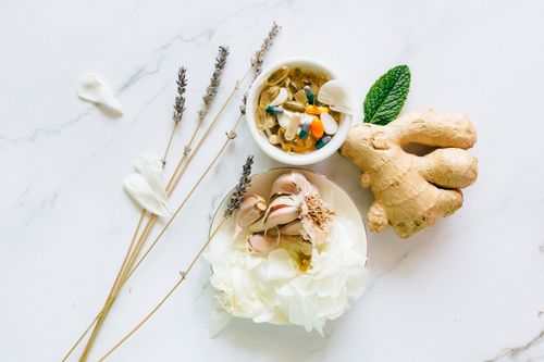 Free Flat lay of ginger, garlic, flowers, and supplements for holistic health. Stock Photo