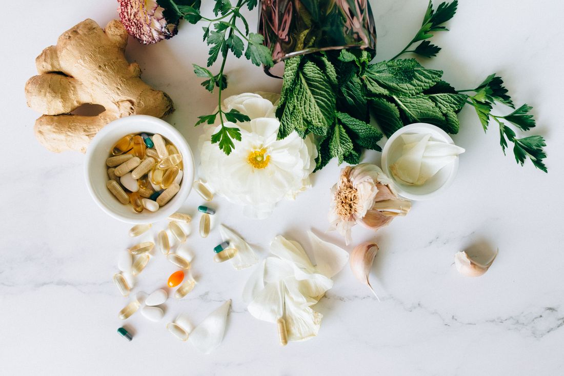 Fresh ginger and herbs arranged on marble