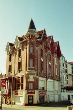 A stunning Gothic Revival style brick building captured on a sunny day, showcasing intricate architecture.