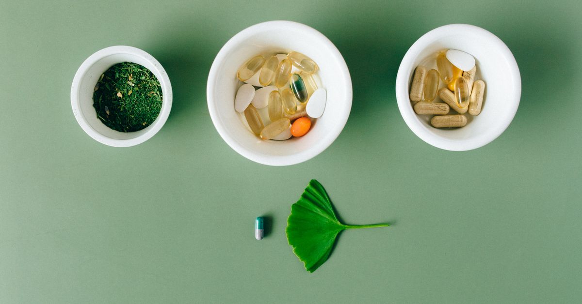 Supplement capsules and a glass of water