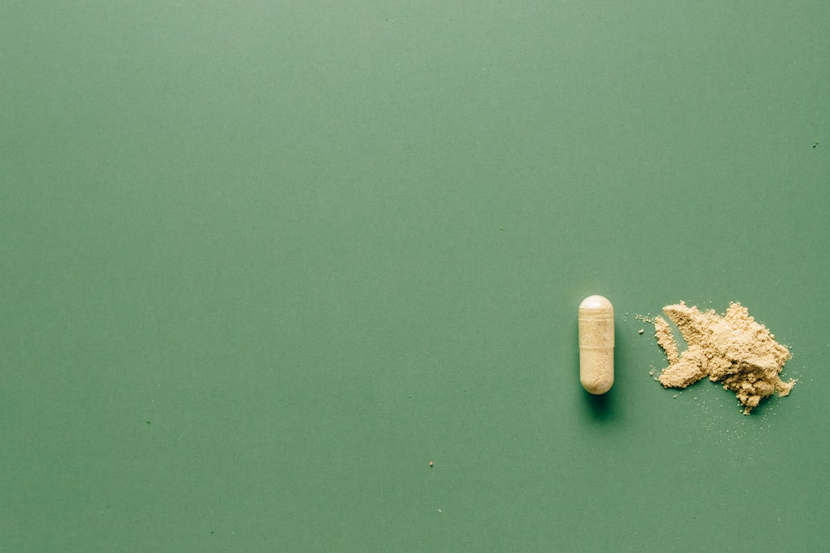 Medication Pill on Green Background