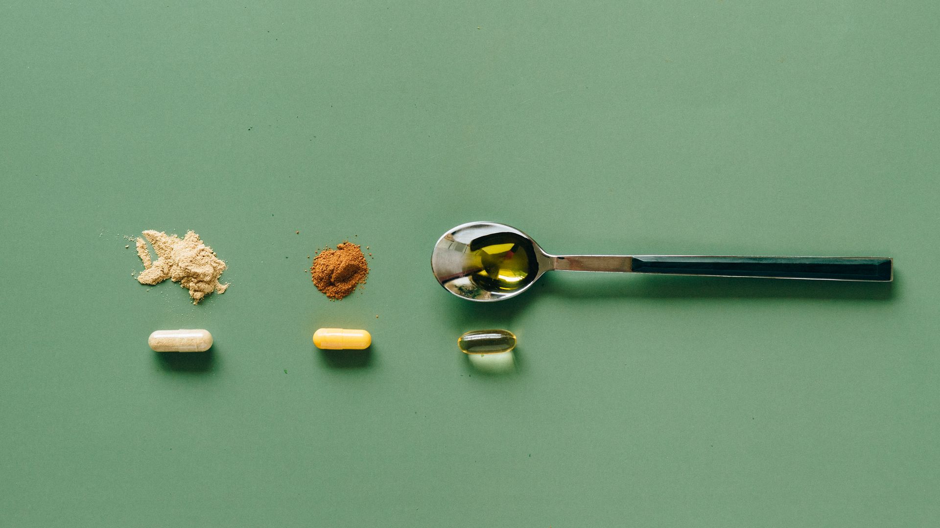 Safe Cognitive Enhancers: Exploring Options for Boosting Brain Power Top view of various supplements and powders on a green surface with a spoon — safe cognitive enhancers