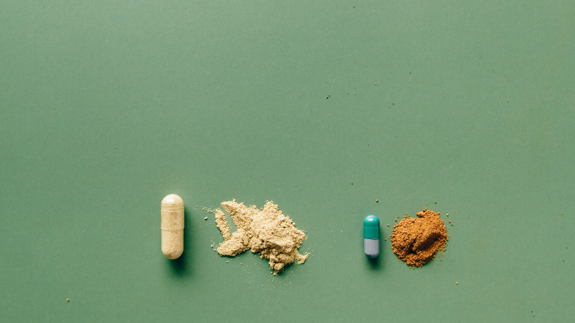 Modafinil vs Green Tea Extract: A Comprehensive Comparison Variety of capsules and powders showcasing natural and pharmaceutical remedies on a green backdrop — modafinil vs green tea extract