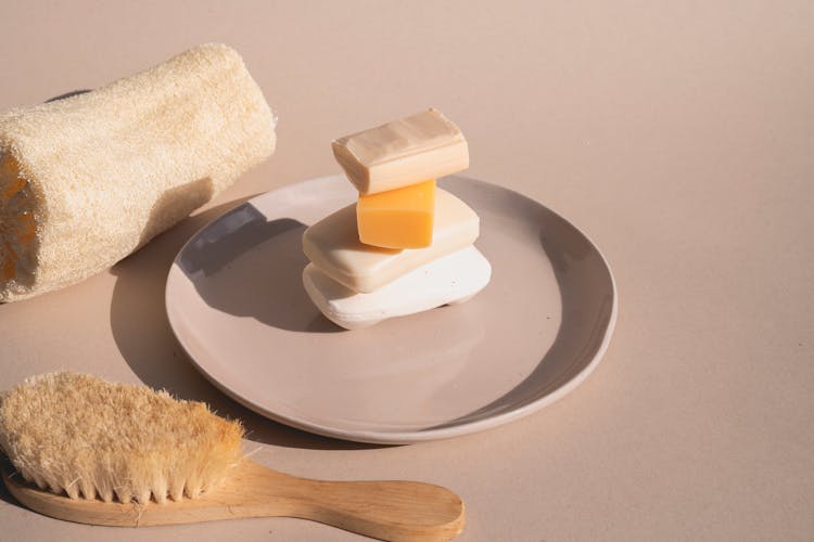 A Stack Of Bar Soaps On Ceramic Plate