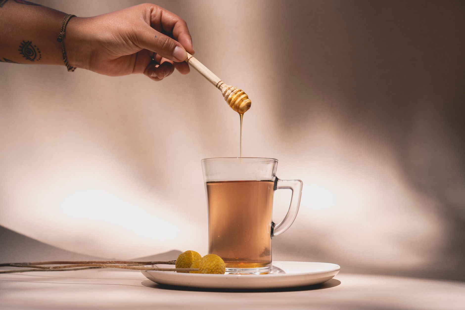 Drizzling hot honey on fried chicken