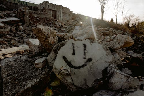 Smiley face on stone in destroyed area