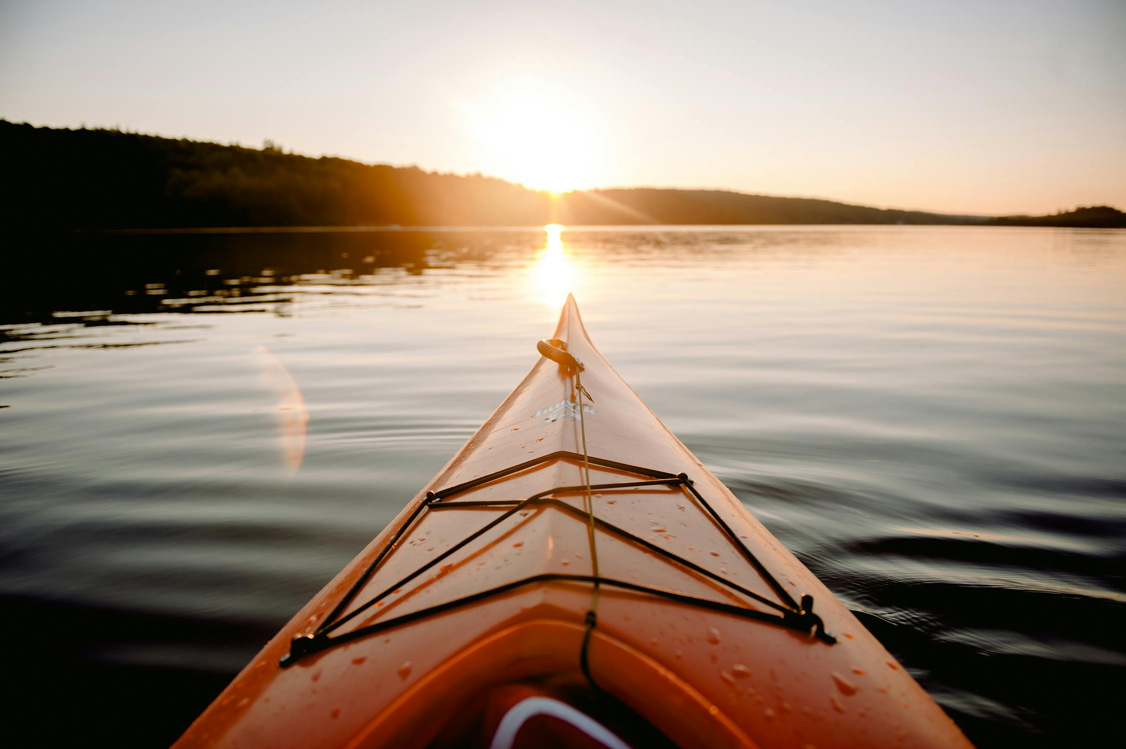 Kayak on the water at sunrise. 