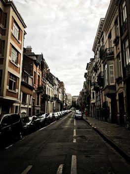 Explore the picturesque architecture of Brussels, Belgium with this image of a quaint, narrow street.