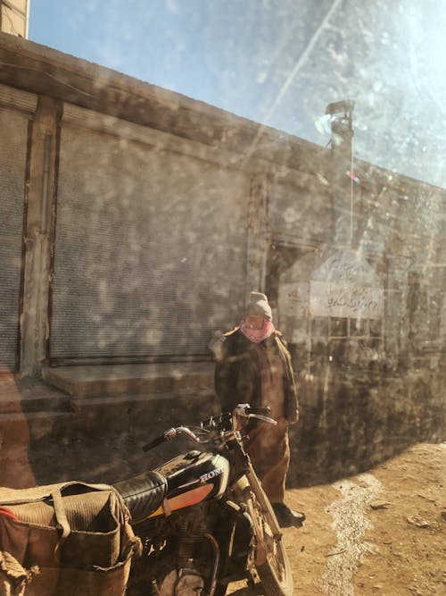 Man in Black Jacket Standing in Front of Motorcycle