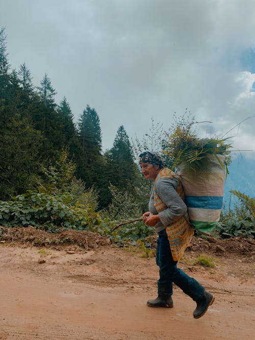 Woman Carrying a Sack of Green Leaves