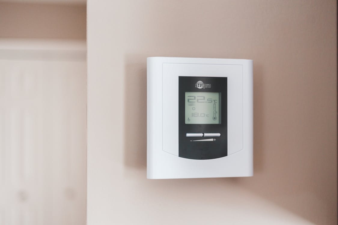 Free White Thermostat Hanging on the Wall Stock Photo