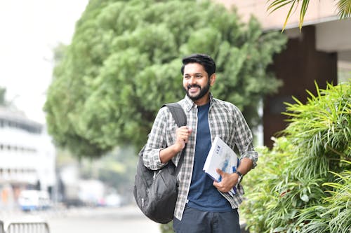 Free A Man with Backpack Smiling Stock Photo