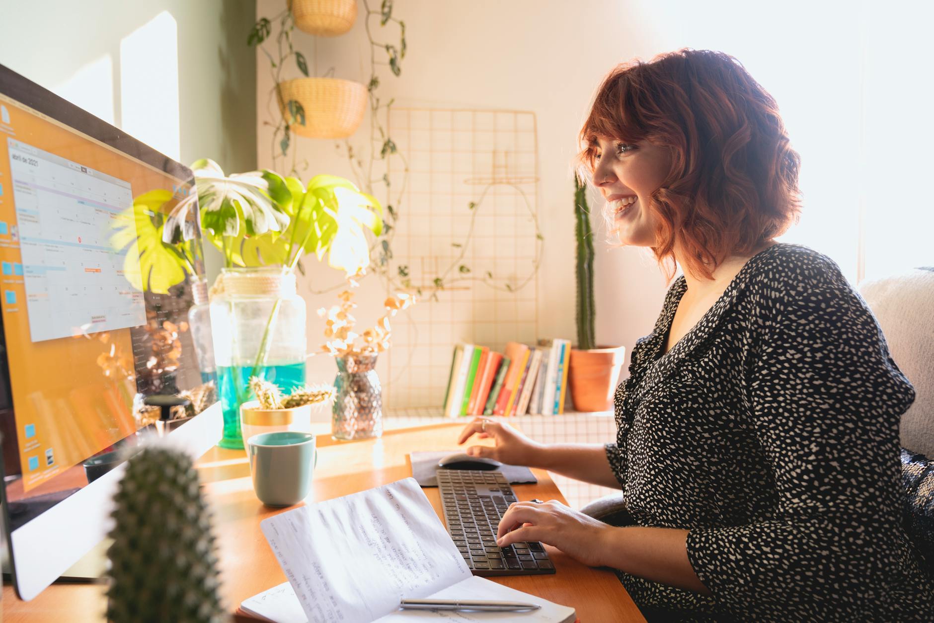 Woman Smiling while Using iMac