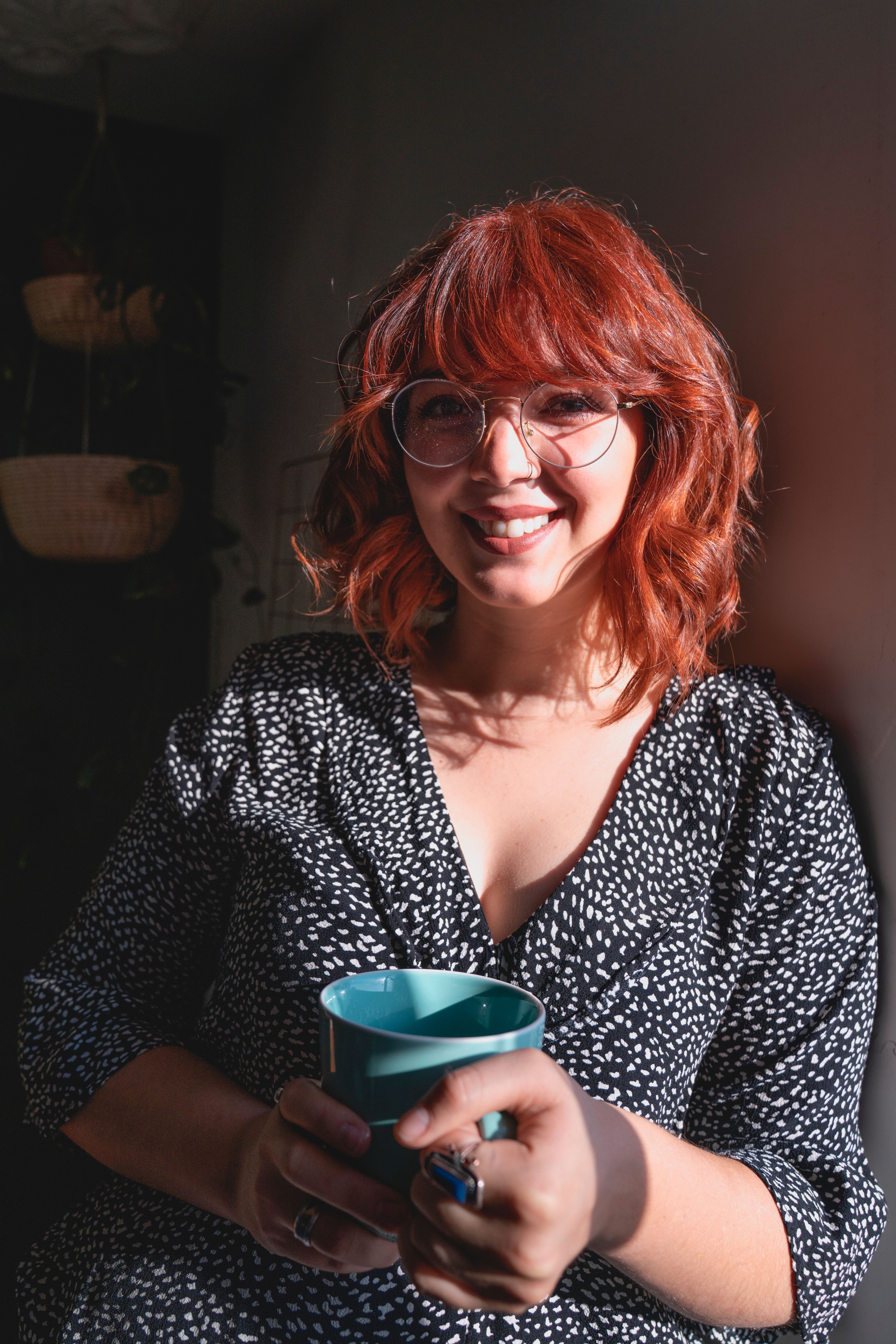Woman Smiling while Holding a Cup · Free Stock Photo