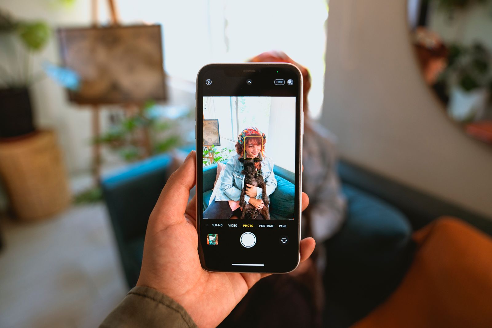 A pet creator photographing a woman with her dog for social media content