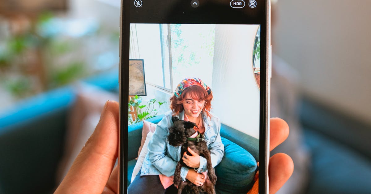 Person Taking Photo of Woman with Her Dog