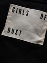 From above of cotton cloth label with minimalist inscription placed on black surface