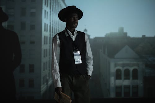 Free A Man Holding a Folded Newspaper  Stock Photo