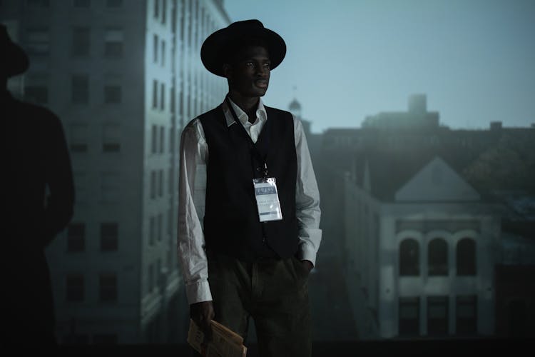 A Man Holding A Folded Newspaper 