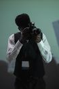 Man in Black Leather Jacket Holding Black Dslr Camera