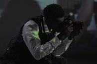 Man in White Dress Shirt Holding Black Dslr Camera