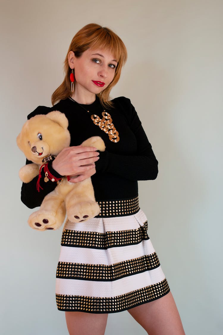 Charming Young Female Holding Toy Bear