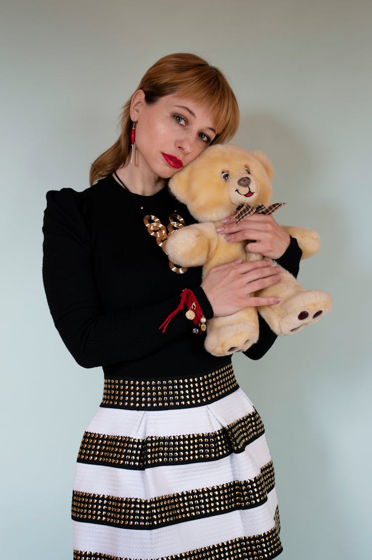 Woman In Black Outfit Hugging Teddy Bear