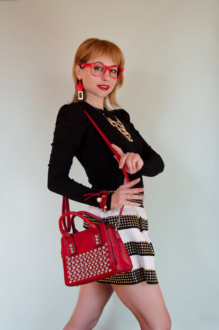 Confident Woman With Red Handbag And Eyeglasses