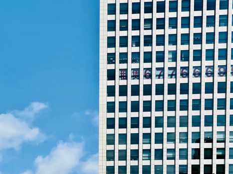 High-rise building facade with glass windows and urban skyline view.