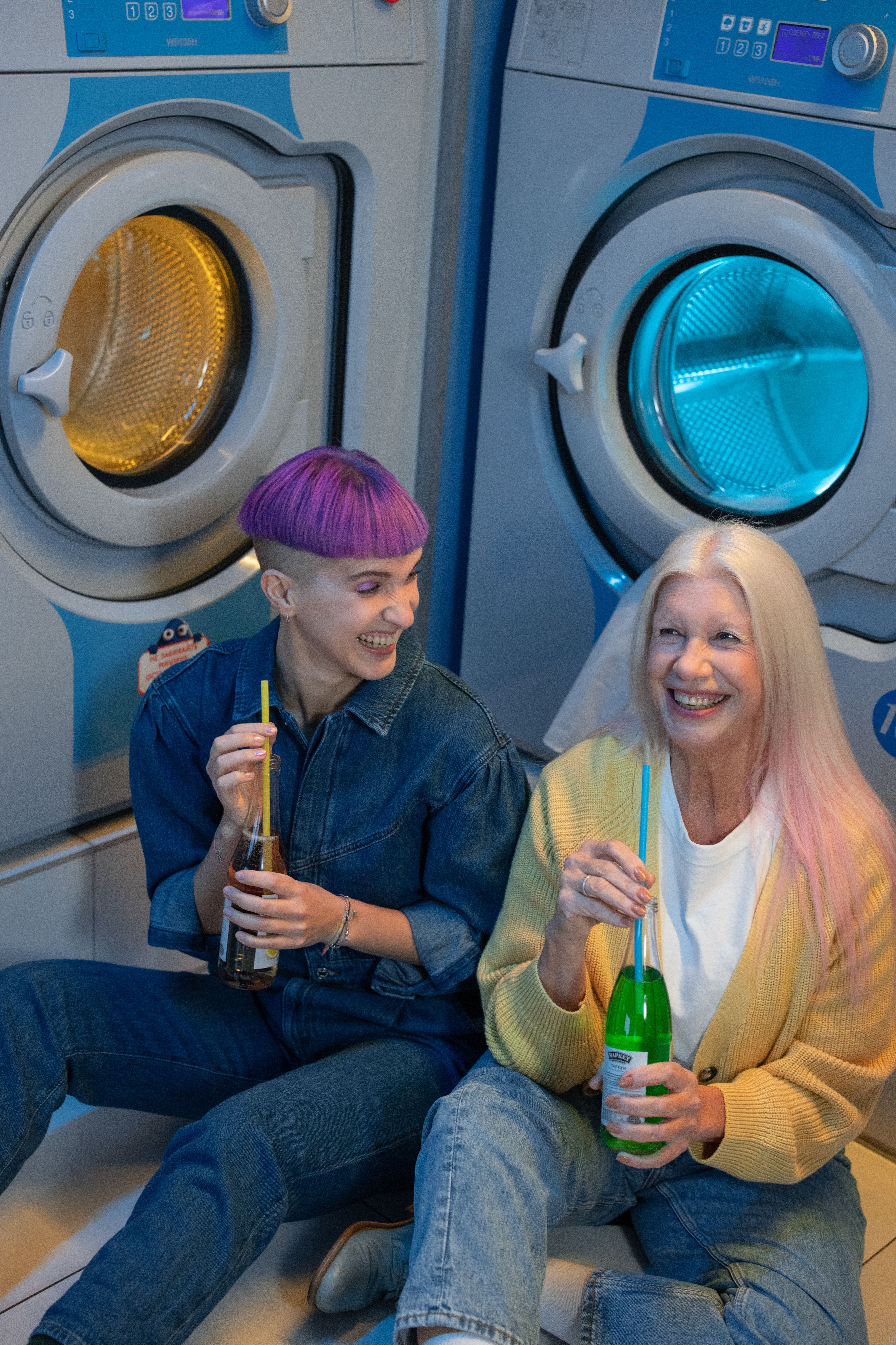 This image shows employees spending work hours waiting beside commercial laundry machines instead of focusing on business tasks.