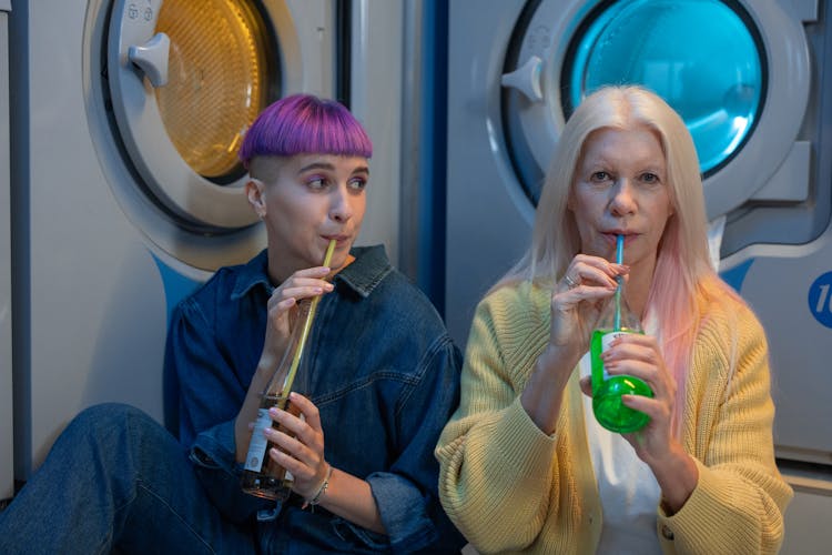 Women Drinking Juice On A Bottle 