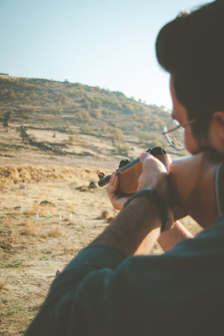 An Animal Hunter Holding A Rifle 