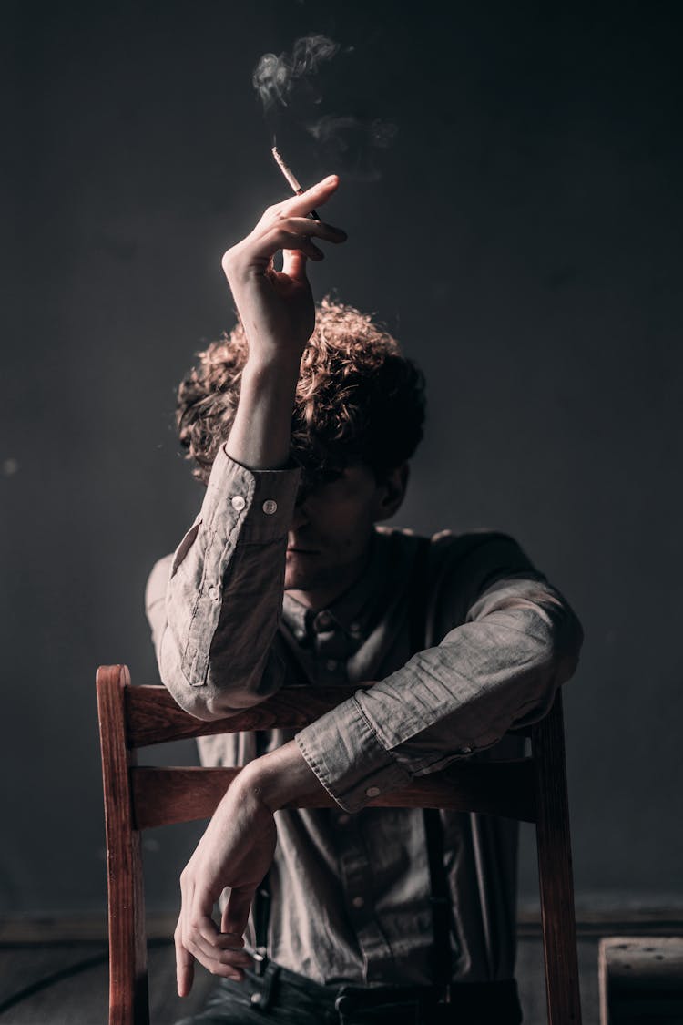 Unrecognizable Man Smoking In Studio