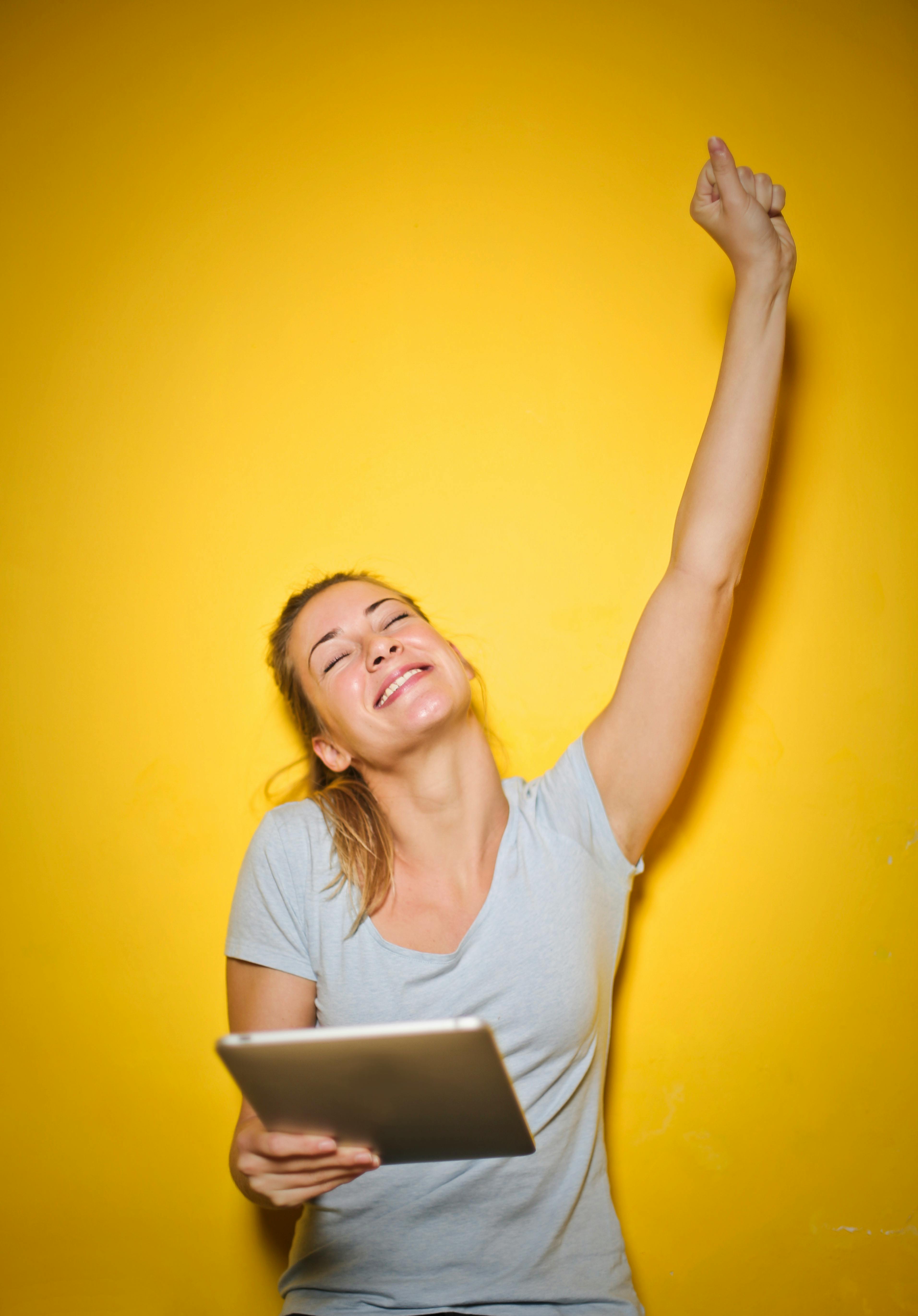 photo of a woman holding an ipad