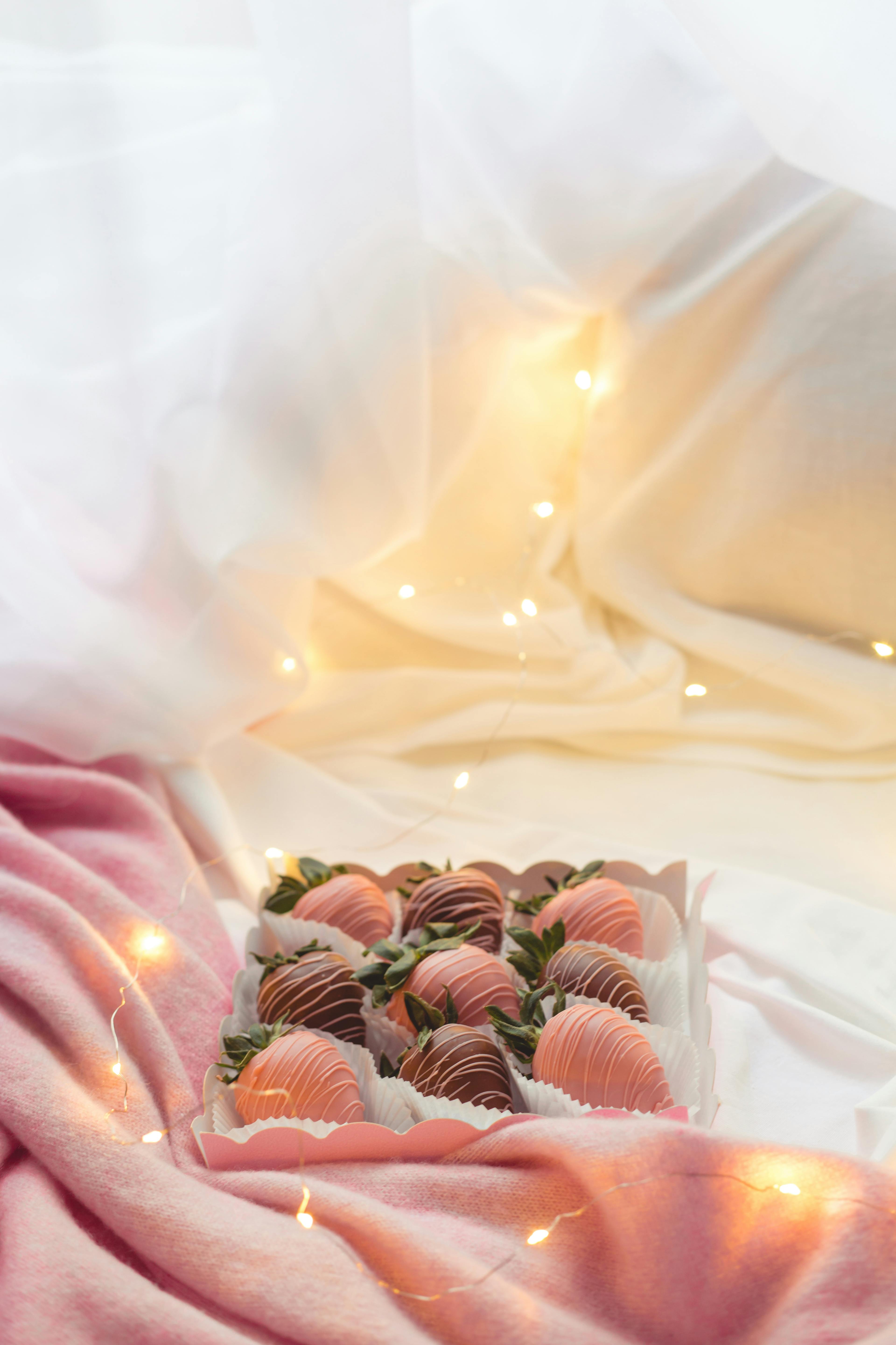A beautiful setup of chocolate-covered strawberries with warm lighting for a luxurious dessert presentation.