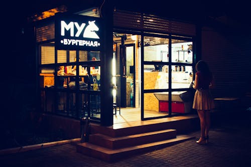 Photography of Woman Standing Near Restaurant