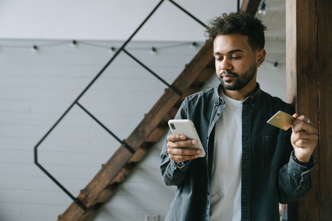 Man in Black Jacket Holding White Ceramic Mug