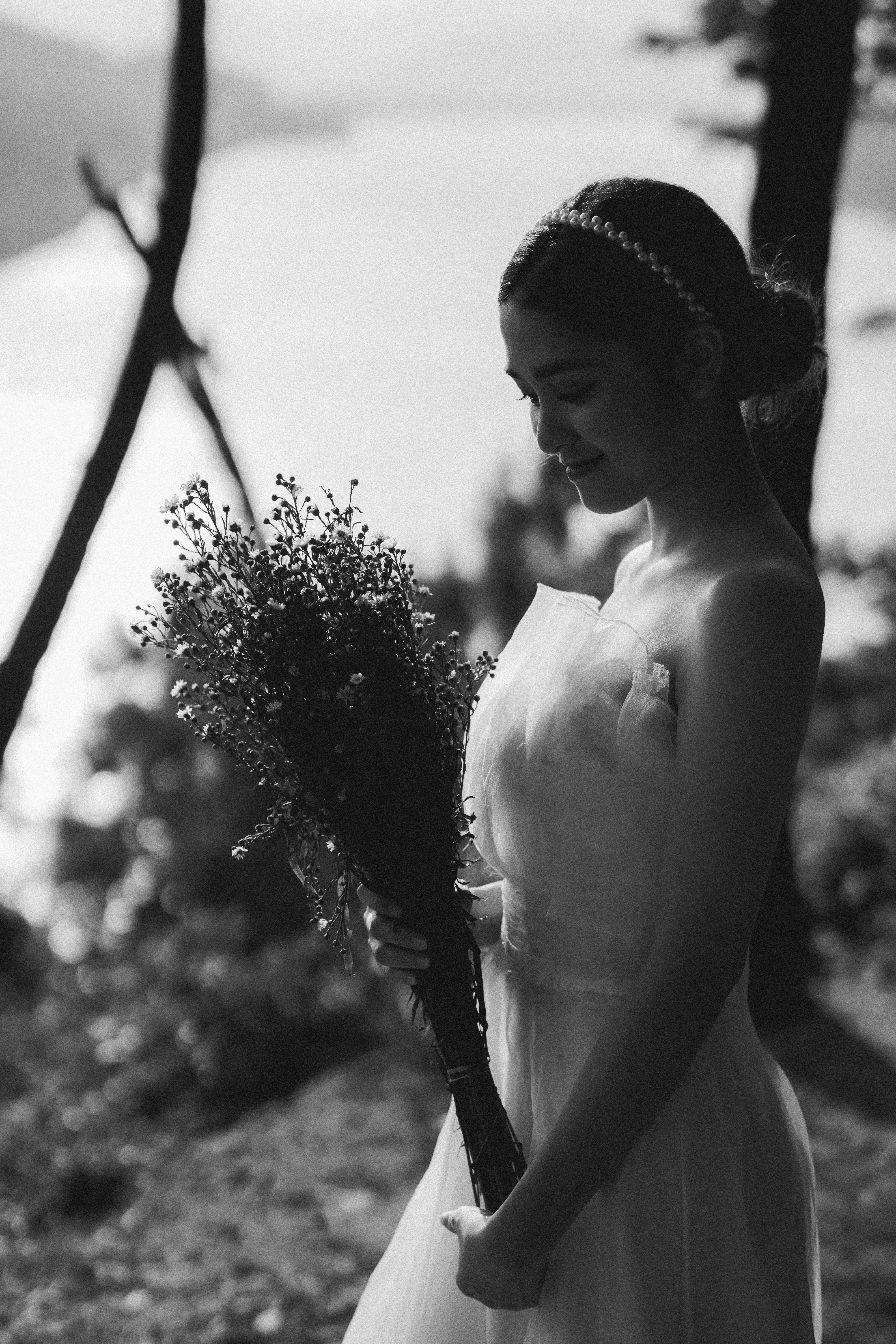 A Grayscale Photo of a Woman Holding a Bouquet of Flowers · Free Stock ...