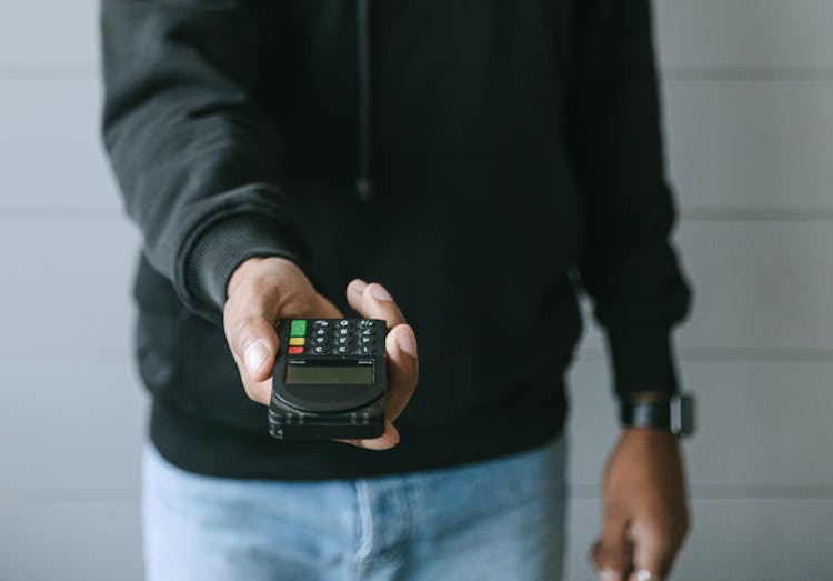 Person In Black Long Sleeve Shirt Holding Black Smartphone