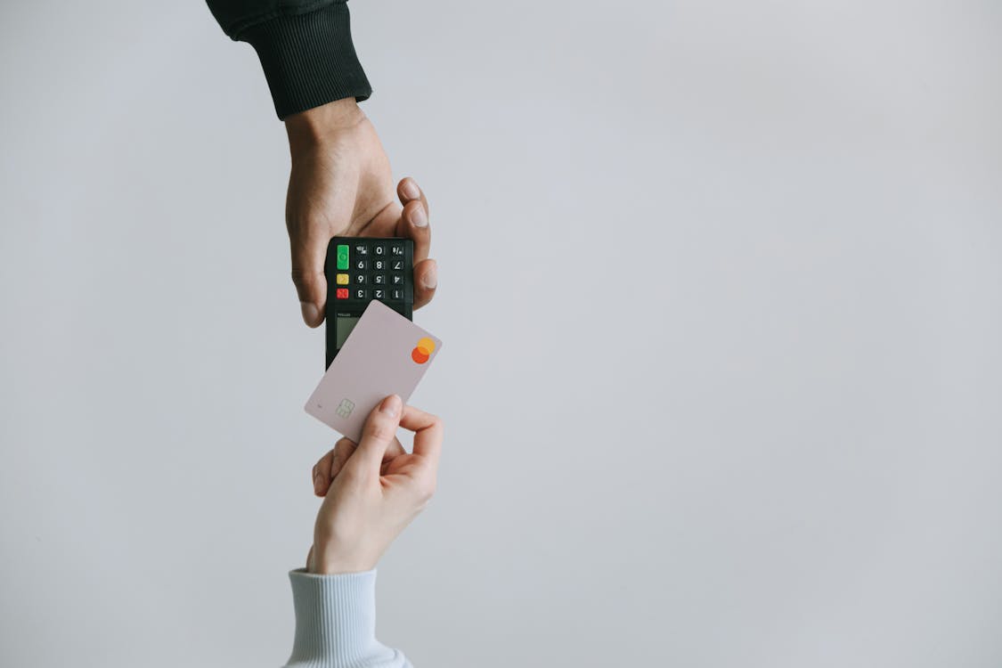 Free Person Holding White and Black Smartphone Stock Photo