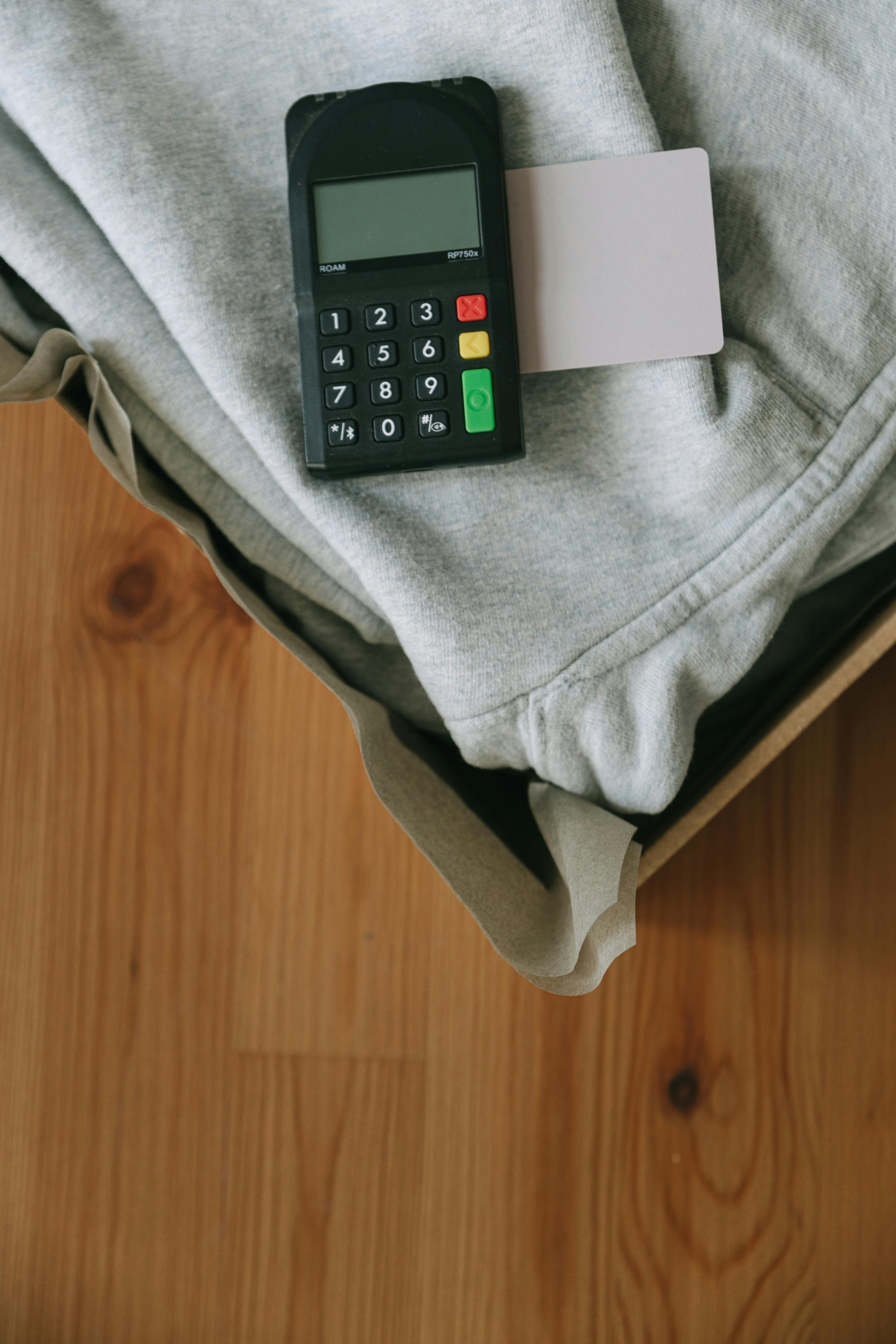 black remote control on gray textile