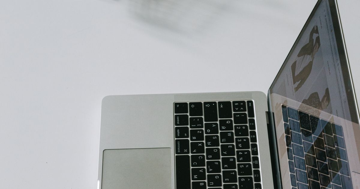 Laptop beside a miniature shopping cart