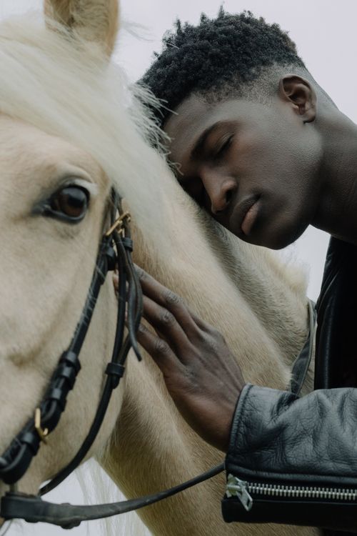 Free A close-up of a man affectionately leaning against a horse, highlighting connection. Stock Photo